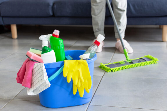 bucket-with-bottles-detergent-cleaning-equipment-housewife-cleaning-floor-with-mopping-stick